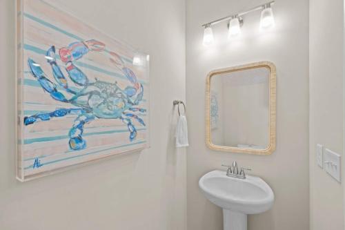 a bathroom with a painting of a crab on the wall at Modern Retreat Minutes to Emerald Isle Beach Villa in Cedar Point