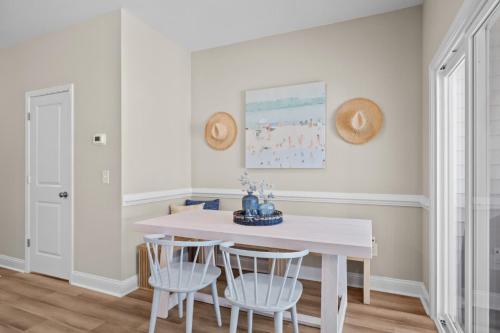 a white dining room with a white table and chairs at Modern Retreat Minutes to Emerald Isle Beach Villa in Cedar Point
