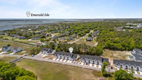 an aerial view of a resort with trees and a beach at Modern Retreat Minutes to Emerald Isle Beach Villa in Cedar Point
