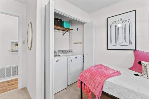 a white room with a bed and a kitchen at The Duke Retreat Close to Duke & Downtown Villa in Durham
