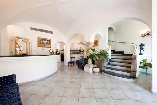 
a large room with a large staircase leading up to it at Hotel Reginella in Positano

