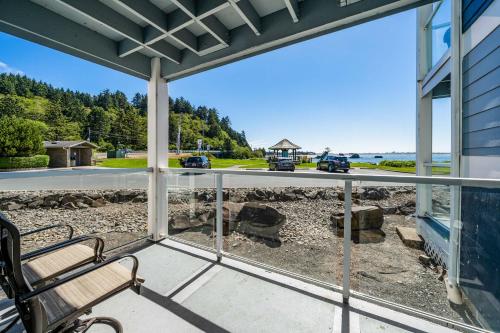a porch with a bench and a view of a road at Waters Edge 103 in Lincoln City