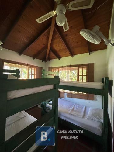 two bunk beds in a room with a ceiling at Casa Quinta Melgar in Melgar