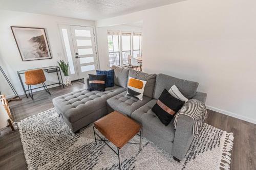 a living room with a couch and a table at Cozy Cove Cottage in Seaside