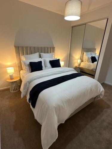 a bedroom with a large bed with a large mirror at Straun Street House in Naracoorte