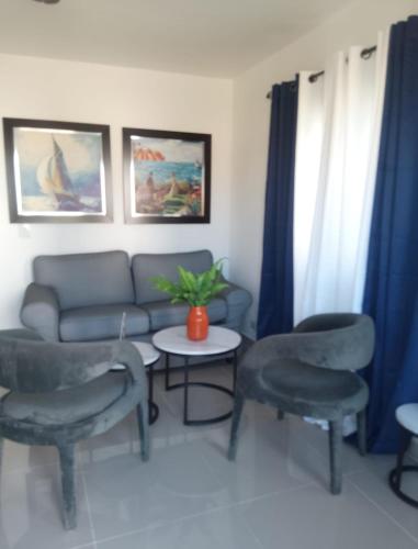 a living room with a couch and chairs and a table at Ligas Mayores Residence in Boca Chica