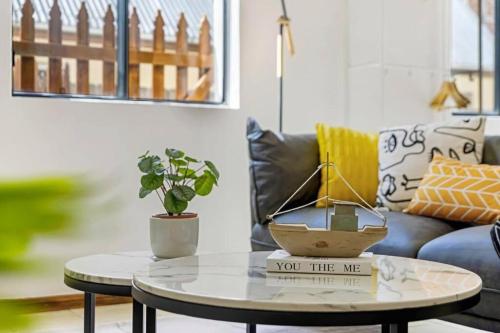 a living room with a coffee table and a couch at Cheerful Two Bedroom house in Sydney