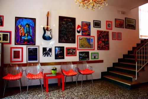 una stanza con sgabelli rossi e una parete d'arte di Hotel Villa Elia a Rimini