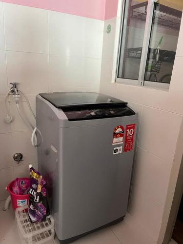 a small refrigerator in the corner of a room at D Cerrum Homestay Eco H in Semenyih