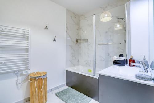 a white bathroom with a shower and a sink at Lafya : ParisNord, Villepinte, CDG, StadedeFrance in Le Blanc-Mesnil