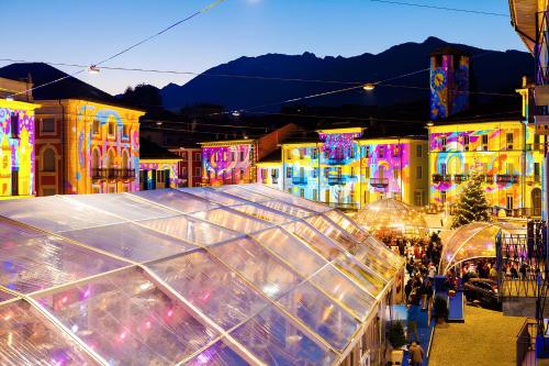 a view of a city with a building with lights at Locarno Center - Free Parking, Netflix and WiFi in Locarno