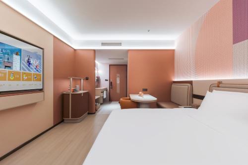 Katil atau katil-katil dalam bilik di Orange Hotel Shanghai Lingang New City Wanda Plaza