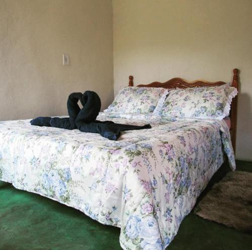 a bedroom with a bed with two stuffed animals on it at Cachoeira do Galvão in Delfinópolis