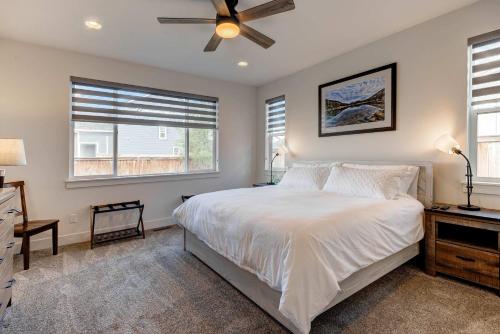 a bedroom with a bed and a ceiling fan at Scenic Modern Home with Private Patio & Fireplace in Belgrade