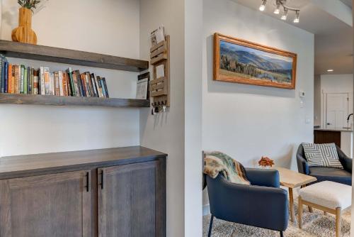 a living room with a book shelf and a dining room at Scenic Modern Home with Private Patio & Fireplace in Belgrade