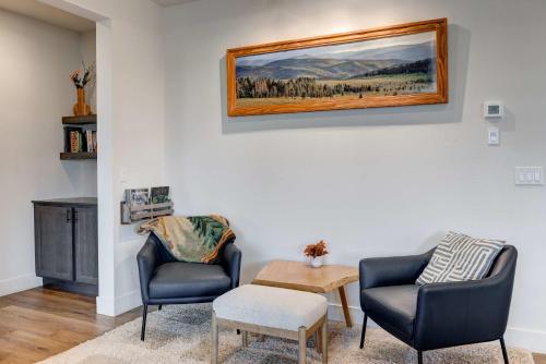a living room with two chairs and a table at Scenic Modern Home with Private Patio & Fireplace in Belgrade