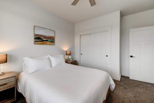 a bedroom with a white bed and a white door at Scenic Modern Home with Private Patio & Fireplace in Belgrade