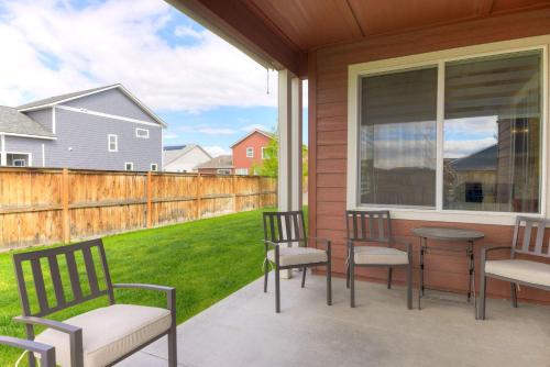 a porch with chairs and a table and a window at Scenic Modern Home with Private Patio & Fireplace in Belgrade