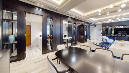 a dining room with a black table and chairs at Kimpton Margot Sydney by IHG in Sydney