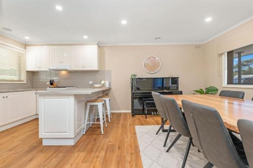 a kitchen and dining room with a table and chairs at The Great Escape - Echuca Holiday Homes in Moama