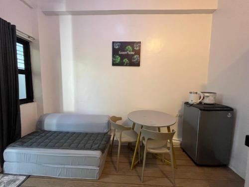 a small room with a bed and a table at San Jose del monte Bulacan gumaok with aircon unit 1 in Mangangpico