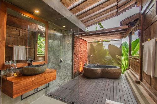 a bathroom with two sinks and a large shower at TUJUH Angel by GenuineHost in Ubud