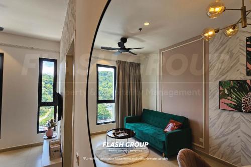 a living room with a green couch and a window at Paxtonz Premium Suites Petaling Jaya in Petaling Jaya