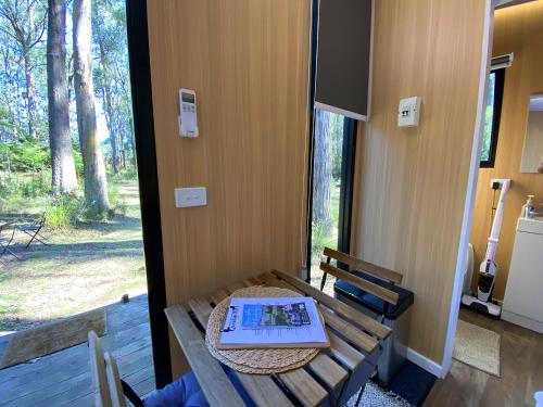 a room with a table with a laptop on it at Quantum Field by Tiny Away in Toolangi