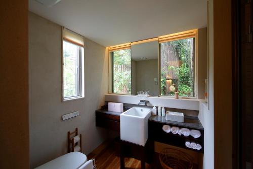 a bathroom with a sink and a mirror at 奥武雄温泉　風の森 in Ureshino
