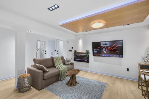a living room with a couch and a tv on a wall at Pinnacle of Luxury & Leisure- 2 BDM,2 BATH, KITCHEN in Whitby