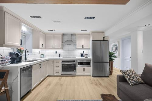 a kitchen with white cabinets and stainless steel appliances at Pinnacle of Luxury & Leisure- 2 BDM,2 BATH, KITCHEN in Whitby