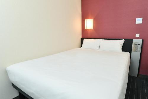 Postel nebo postele na pokoji v ubytování Sanco Inn Nagoya Fushimi
