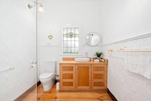 a bathroom with a toilet and a sink and a shower at Orontes Cottage - Geelong Rippleside Retreat in Geelong