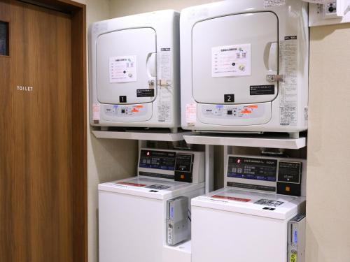 a room with four machines on a shelf at Dormy Inn Sapporo Annex in Sapporo
