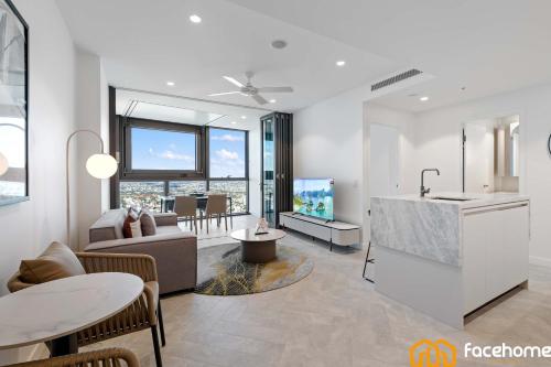 a living room with a kitchen and a living room with a couch at City Luxury Stay River & City Access in Brisbane