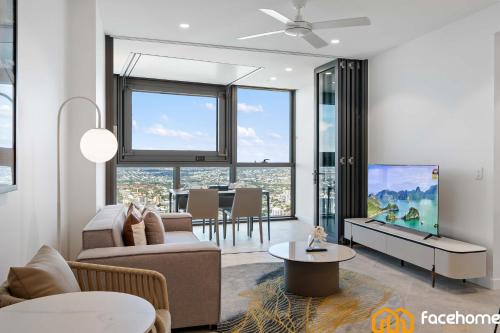 a living room with a couch and a tv at City Luxury Stay River & City Access in Brisbane