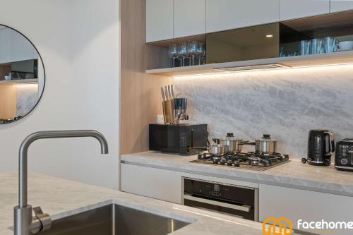 a kitchen with a stove with pots and pans at City Luxury Stay River & City Access in Brisbane