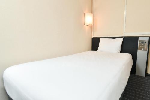 Ένα ή περισσότερα κρεβάτια σε δωμάτιο στο Sanco Inn Nagoya Fushimi