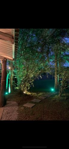 a night view of a building with green lights at Containerhaus in Carlos Barbosa