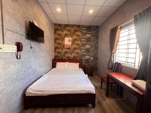 a bedroom with a bed and a tv in it at Trung Hau Hotel in Can Tho