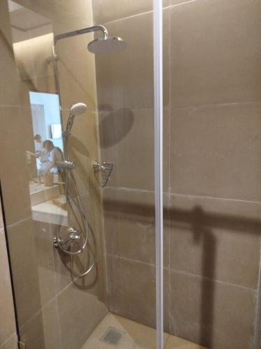 a shower with a glass door in a bathroom at Oak Ray Tea Bush in Ramboda