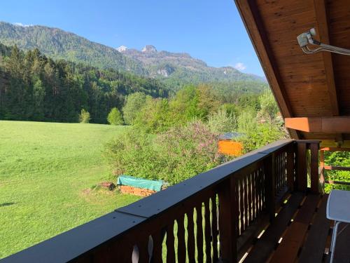 a balcony with a view of a field and mountains at Apartment in St. Jakob im Rosental in Sankt Jakob im Rosental