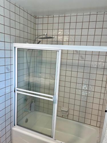 a tiled bathroom with a shower and a tub at Mountain View Poolside Retreat in Agoura Hills