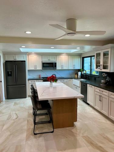 a large kitchen with a large island in the middle at Mountain View Poolside Retreat in Agoura Hills