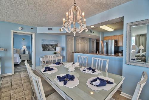 a dining room and kitchen with a dining table and chairs at Oceanfront Crescent Shores Unit 106-Sleep12-4 bedrooms-6 beds-3 bathrooms in North Myrtle Beach
