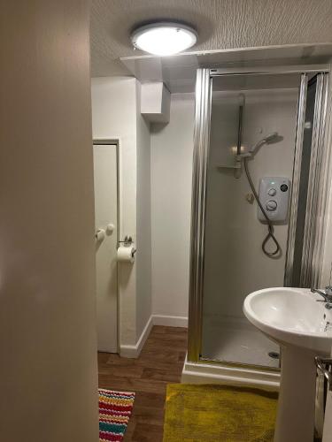 a bathroom with a shower and a sink at Hallmark Guest House in Aberdeen