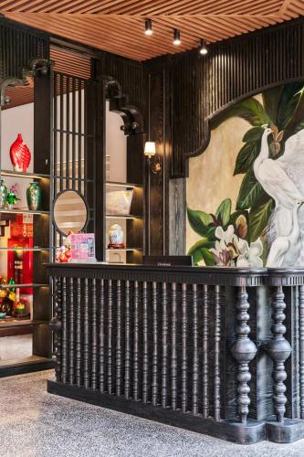 a dressing room with a mirror and a painting on the wall at Eden Hotel Cát Bà in Cat Ba