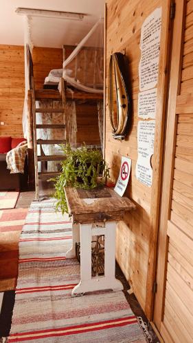 a wooden room with a bench and a bunk bed at BB Polle - with the horse view in Mikkeli