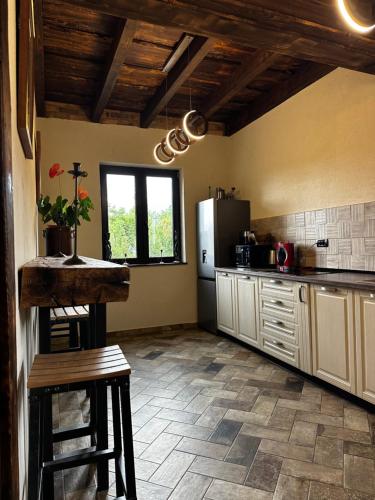 a kitchen with a refrigerator and a table in it at Stone House Bran in Tohanu Nou