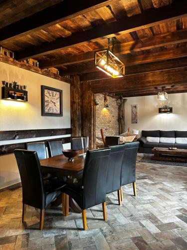 a dining room with a wooden table and chairs at Stone House Bran in Bran